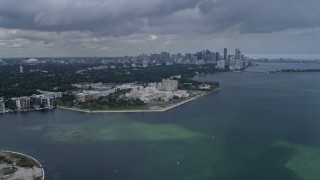 6.7K aerial stock footage flyby Grove Isle condo complexes toward Downtown Miami, Florida, for view of hospital Aerial Stock Footage | AX0172_015