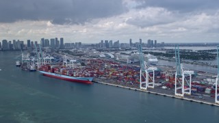 6.7K aerial stock footage of cruise ships docked at the Port of Miami, Florida, with the city's skyline in the background Aerial Stock Footage | AX0172_020