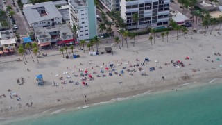 6.7K aerial stock footage of sunbathers enjoying the beach in Hollywood, Florida Aerial Stock Footage | AX0172_036