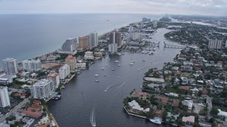 AX0172_061 - 6.7K aerial stock footage of boats in a canal and coastal neighborhoods in Fort Lauderdale, Florida