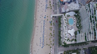 AX0172_062 - 6.7K aerial stock footage of tilting to a bird's eye view of sunbathers on the beach in Fort Lauderdale, Florida