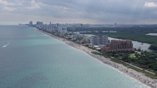 AX0172_067 - 6.7K aerial stock footage of flying past beachfront hotels and condos in Hollywood, Florida