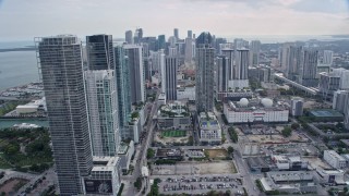 6.7K aerial stock footage tilt from freeway by performing arts center, reveal skyscrapers in Downtown Miami, Florida Aerial Stock Footage | AX0172_088