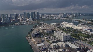 AX0172_122 - 6.7K aerial stock footage of waterfront skyscrapers and city park, reveal cruise ships at the port in Downtown Miami, Florida