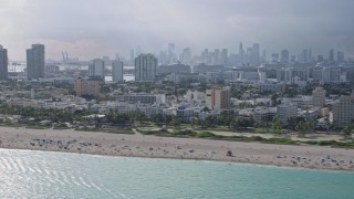 6.7K aerial stock footage of passing by South Beach, Florida with the Miami skyline in the distance Aerial Stock Footage | AX0172_143