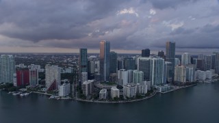 AX0172_170 - 6.7K aerial stock footage of flying by Downtown Miami skyscrapers overlooking the bay, Florida at sunset