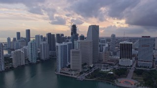 6.7K aerial stock footage of passing tall skyscrapers, reveal the river and Brickell Key in Downtown Miami, Florida at sunset Aerial Stock Footage | AX0172_175