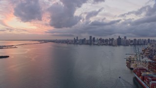 6.7K aerial stock footage fly over the port and Biscayne Bay toward Downtown Miami skyline at sunset, Florida Aerial Stock Footage | AX0172_198