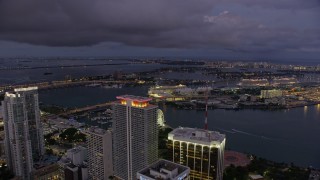 6.7K aerial stock footage of flying over skyscrapers in Downtown Miami toward port and Jungle Island at twilight, Florida Aerial Stock Footage | AX0172_213