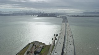 6K aerial stock footage fly over the 80 freeway, tilt to reveal Bay Bridge in Oakland, California Aerial Stock Footage | AX0173_0029