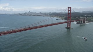 6K aerial stock footage of flying by the iconic Golden Gate Bridge, the city's skyline in the background, San Francisco, California Aerial Stock Footage | AX0173_0057