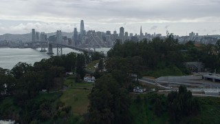 AX0173_0072 - 6K aerial stock footage fly over Coast Guard pier on Yerba Buena Island, reveal Downtown San Francisco skyline, California