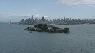 AX0173_0085 - 6K aerial stock footage orbit historic Alcatraz prison, reveal San Francisco skyline, California