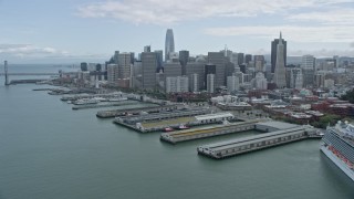 6K aerial stock footage of the San Francisco skyline seen while flying by piers, California Aerial Stock Footage | AX0173_0108