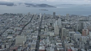 AX0173_0124 - 6K aerial stock footage flying by Nob Hill apartment buildings in San Francisco, California, with view of Alcatraz