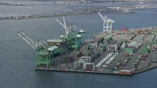 6K aerial stock footage of passing cargo cranes and ship at the Port of Oakland, California Aerial Stock Footage | AX0173_0131