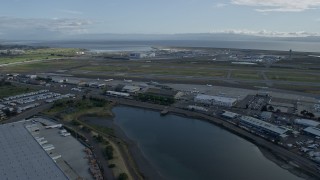 6K aerial stock footage of flying past runways and hangars at Oakland Airport, California Aerial Stock Footage | AX0173_0137