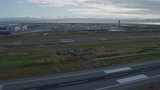 6K aerial stock footage of descending past runways at Oakland Airport, California Aerial Stock Footage | AX0173_0138