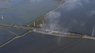 AX0174_0006 - 6K aerial stock footage approaching a San Mateo Bridge toll booth, Hayward, California