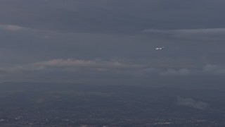 6K aerial stock footage of a commercial plane in flight over Hayward, California Aerial Stock Footage | AX0174_0009