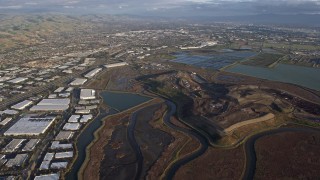 6K aerial stock footage of flying over Fremont marshland near warehouse buildings, California Aerial Stock Footage | AX0174_0017