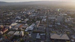 6K aerial stock footage of tilting from urban homes to reveal Downtown San Jose at sunset, California Aerial Stock Footage | AX0174_0029