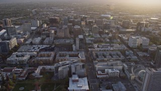 AX0174_0031 - 6K aerial stock footage of flying over Downtown San Jose office and apartment buildings at sunset, California