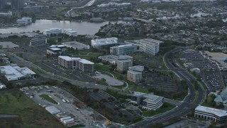 AX0174_0058 - 6K aerial stock footage of flying past office buildings at sunset, Redwood City, California