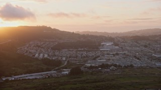 AX0174_0073 - 6K aerial stock footage of suburban neighborhood around the Cow Palace at sunset, Daly City, California