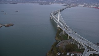 6K aerial stock footage flying by the Bay Bridge at sunset, California Aerial Stock Footage | AX0174_0085