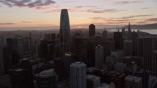 6K aerial stock footage of flying over Downtown San Francisco toward the setting sun, California Aerial Stock Footage | AX0174_0092