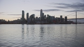 AX0174_0103 - 6K aerial stock footage fly toward Downtown San Francisco skyline from the bay at twilight, California