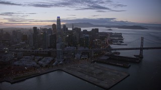 6K aerial stock footage of a reverse view of Downtown San Francisco skyscrapers at twilight, California Aerial Stock Footage | AX0174_0110