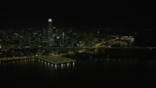 6K aerial stock footage reverse view of Bay Bridge and Downtown San Francisco skyline at night, California Aerial Stock Footage | AX0174_0161