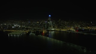 6K aerial stock footage fly over Bay Bridge toward Downtown San Francisco skyline at night, California Aerial Stock Footage | AX0174_0162