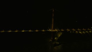 6K aerial stock footage flyby a tower on the Golden Gate Bridge at night, California Aerial Stock Footage | AX0174_0179