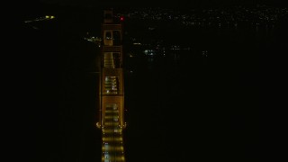 6K aerial stock footage of passing one of the towers on the Golden Gate Bridge at night, California Aerial Stock Footage | AX0174_0182