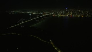 6K aerial stock footage of a wide view of the Bay Bridge and downtown skyline at night, San Francisco, California Aerial Stock Footage | AX0174_0194