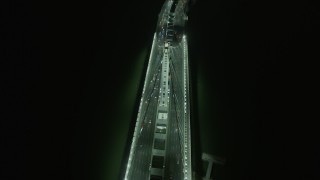 AX0174_0198 - 6K aerial stock footage tilt to bird's eye of cars on the Bay Bridge at night, Oakland, California