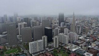 6K aerial stock footage flying past Downtown San Francisco skyscrapers and fog, California Aerial Stock Footage | AX0175_0006