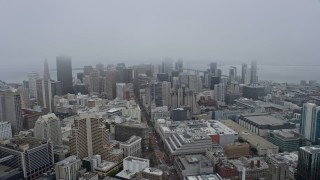 6K aerial stock footage of a view of downtown skyscrapers in San Francisco on a foggy day, California Aerial Stock Footage | AX0175_0016