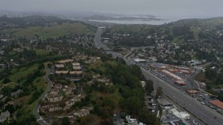 AX0175_0039 - 6K aerial stock footage of Highway 101 through Mill Valley on a foggy day, California