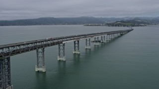 AX0175_0054 - 6K aerial stock footage pan across the Richmond Bridge, fly over the bridge toward San Quentin, California