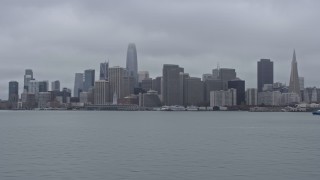 6K aerial stock footage of the Downtown San Francisco skyline on a foggy day, seen from low over the bay, California Aerial Stock Footage | AX0175_0073