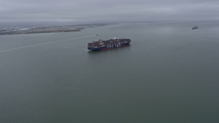 6K aerial stock footage flying toward a cargo ship sailing San Francisco Bay, California Aerial Stock Footage | AX0175_0077