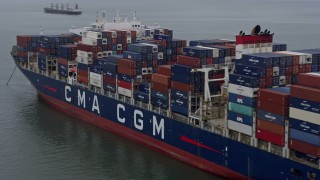 AX0175_0078 - 6K aerial stock footage flying toward a cargo ship sailing San Francisco Bay, California