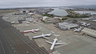 6K aerial stock footage of flying by aircraft parked at Oakland Airport, California Aerial Stock Footage | AX0175_0092