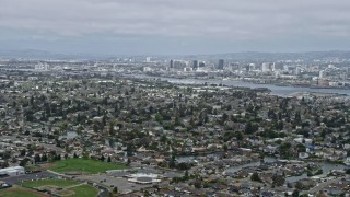 AX0175_0097 - 6K aerial stock footage of Downtown Oakland seen from suburbs in Alameda, California