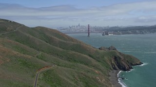 6K aerial stock footage wide view of the Golden Gate Bridge seen while passing the Marin hills, San Francisco, California Aerial Stock Footage | AX0175_0167