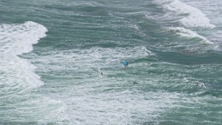 6K aerial stock footage of a kite surfer on ocean waves near the Outer Sunset District, San Francisco, California Aerial Stock Footage | AX0175_0190